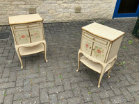 A pair of antique Italian hand painted bedside cabinets